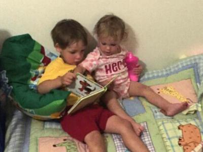 two children reading a book